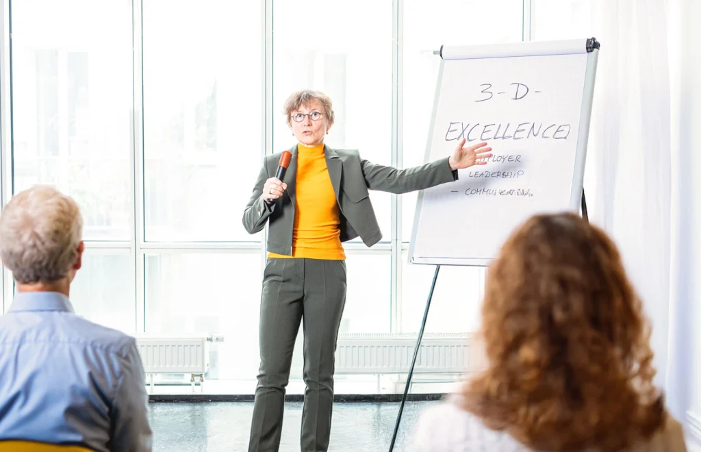 Trainer presenting science leadership concept on flipchart