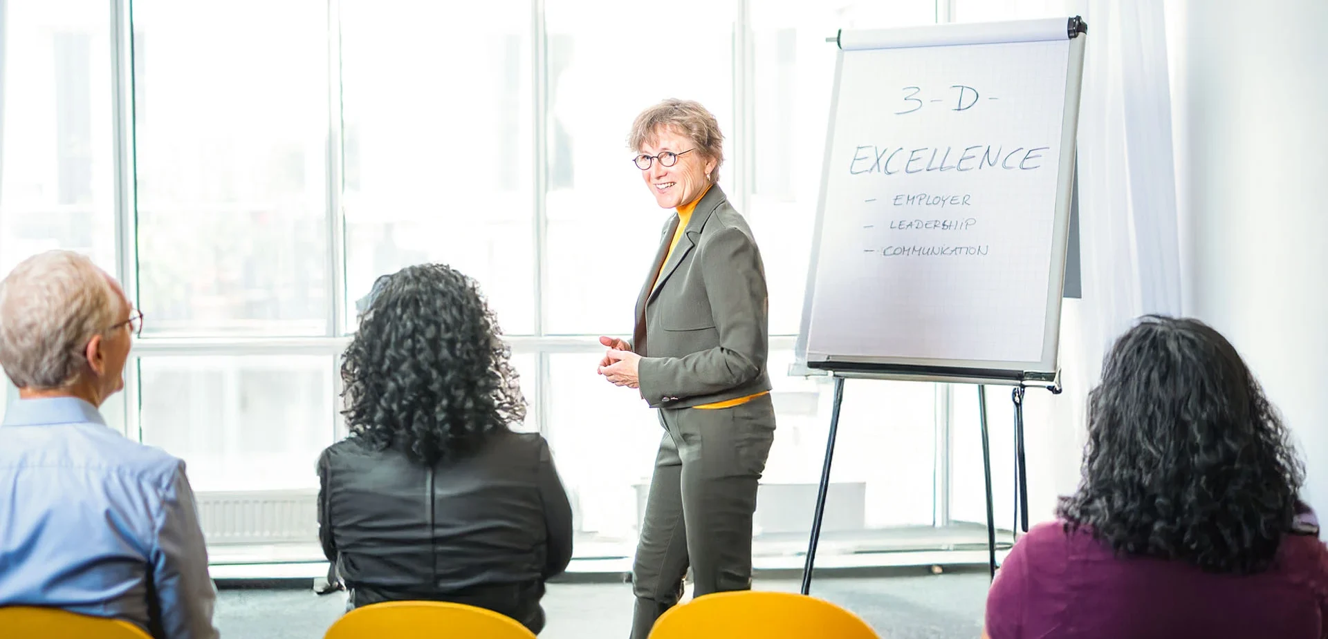 Trainer presenting ideas to participants in workshop setting