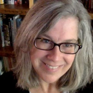 Portrait of a woman with glasses in home office setting